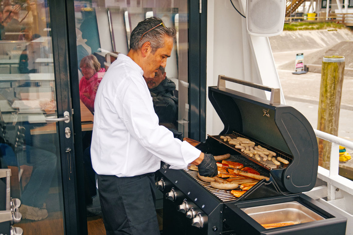 Koch am Grill beim BBQ-Cruise ab Wismar